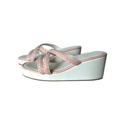 White wedge sandals with pink straps on a white background