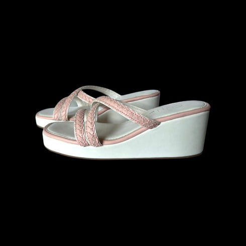 White wedge sandals with pink straps on a white background
