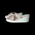 White wedge sandals with pink straps on a white background